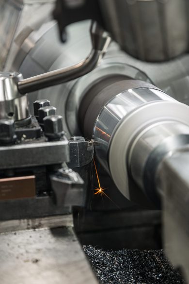 produces metal detail in factory. machine tools for metal working. a metal workpiece is machined by an electric machine. cutting metal modern processing technology. coolant and lubrication.
